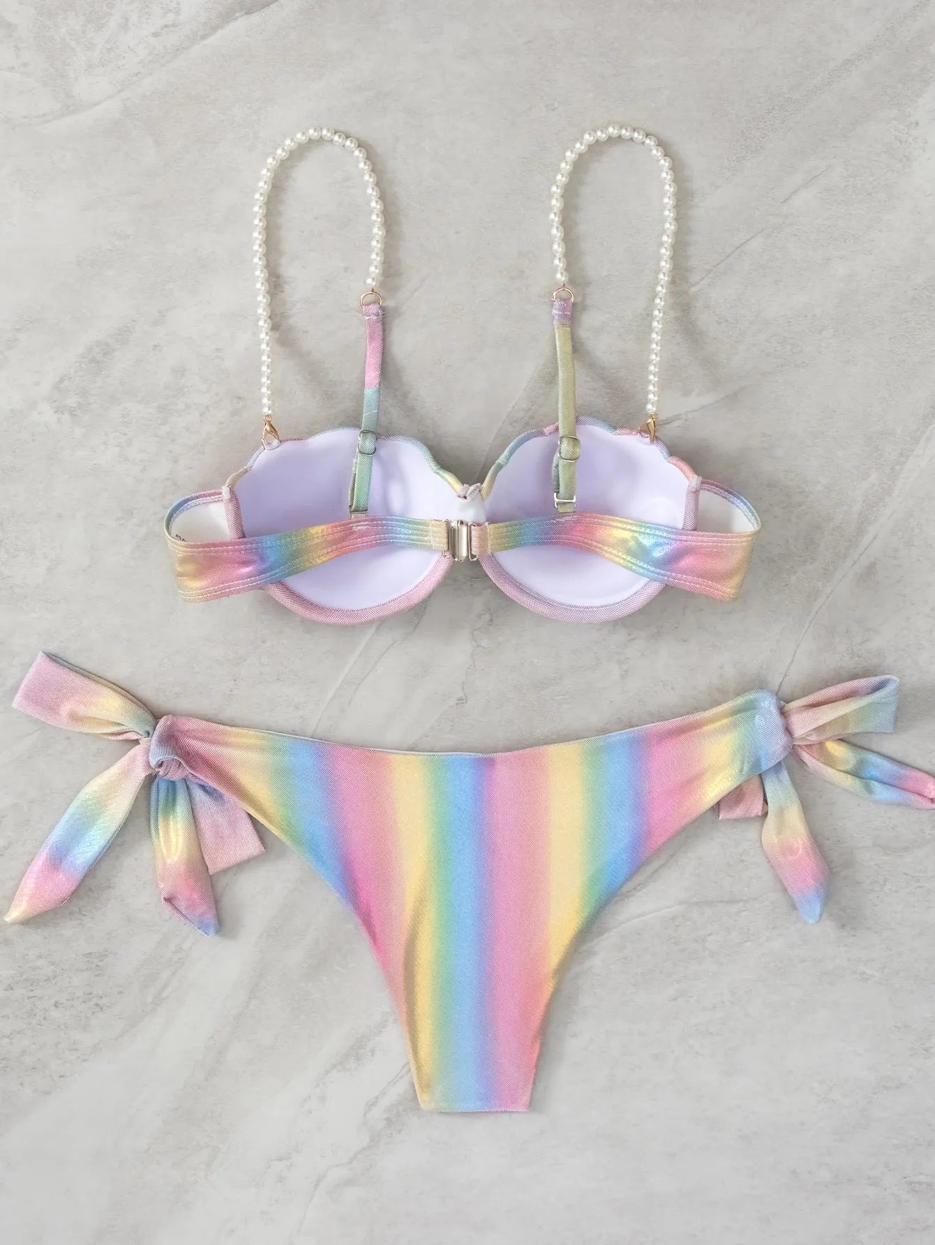 Women's rainbow shell bikini swimsuit with adjustable ties on top and bottom.
