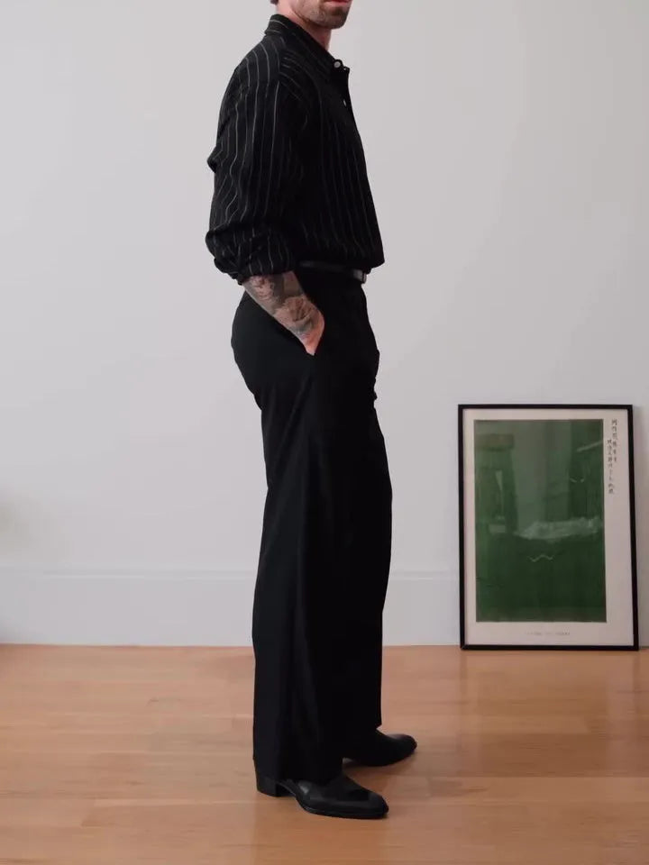 Black and white pinstriped men's long sleeve button-down shirt on a hanger.