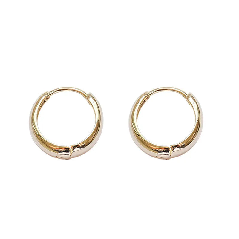 Women's minimalist water drop earrings in gold or silver with geometric round shape