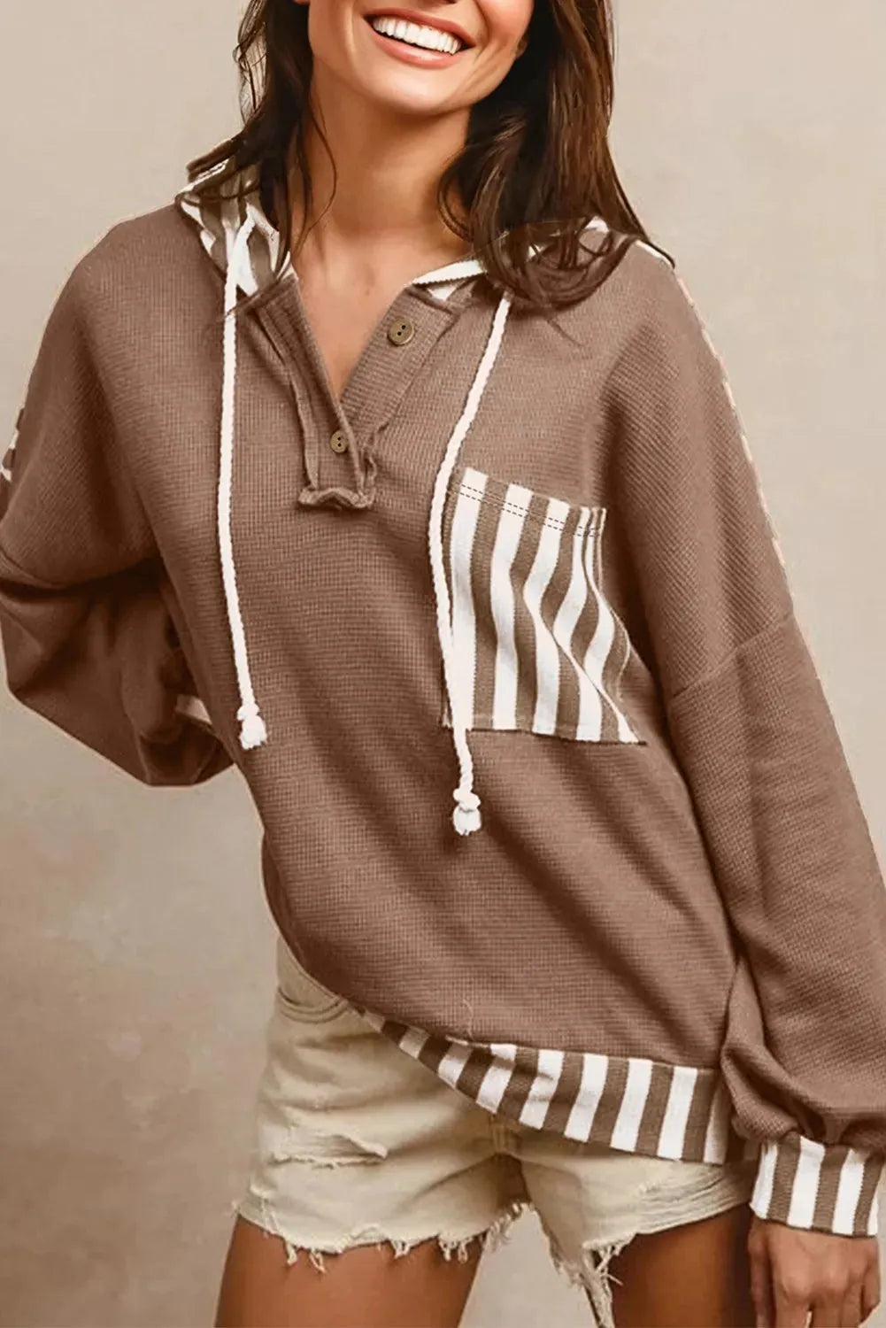 Straw yellow waffle texture hoodie with striped patchwork detail and button neck closure