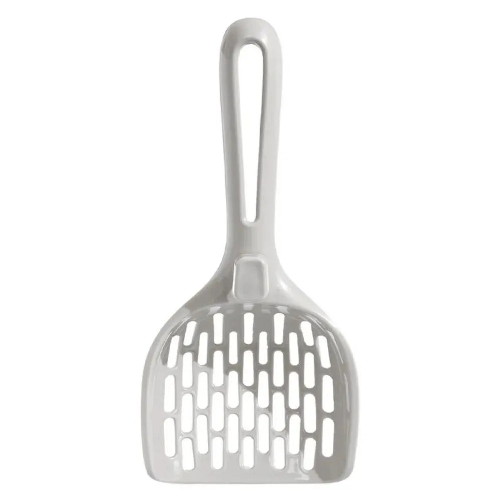 Grey plastic cat litter scoop with attached stand, shown next to a litter box.