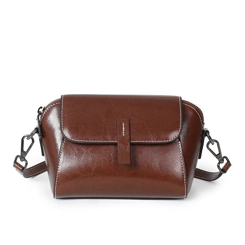 Women's brown oil wax leather messenger bag with crossbody strap and interior compartments