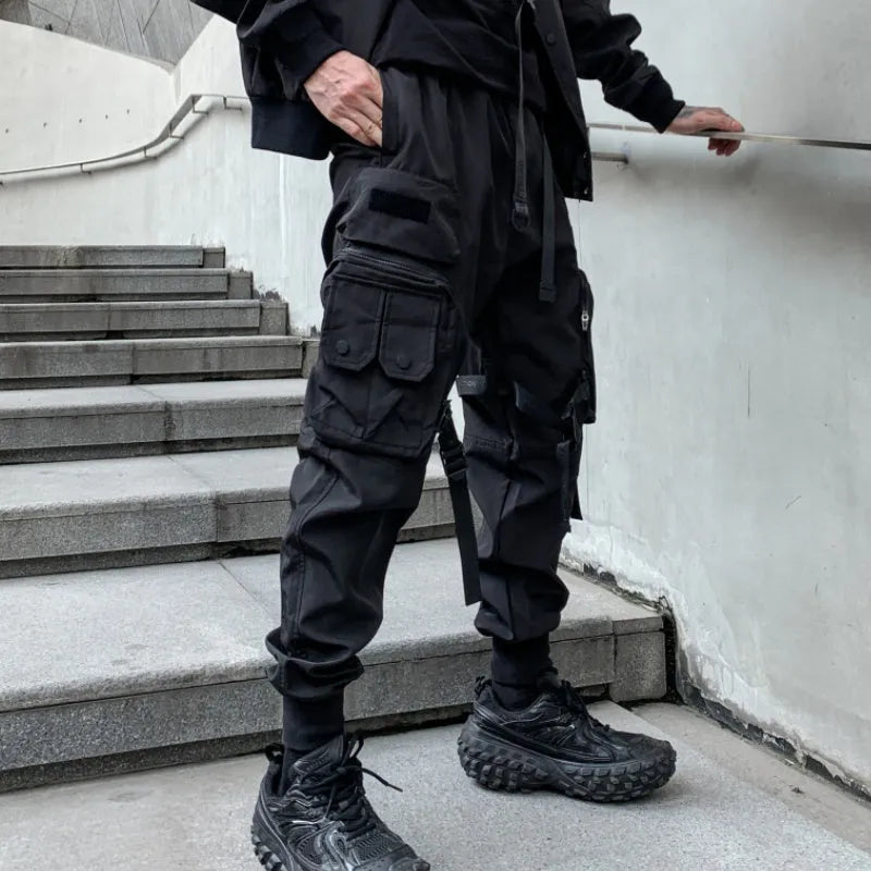 Men's black casual overalls loose fit binding hem trousers front view on mannequin