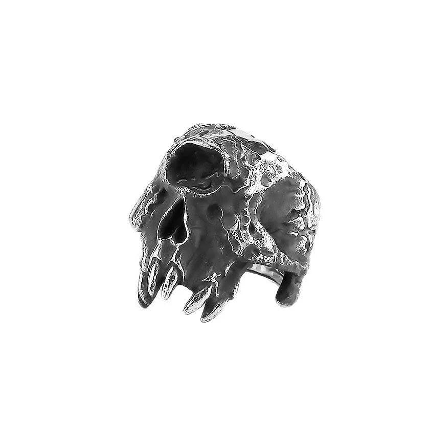 Alloy one-eyed skull ring in retro punk style on a black background.