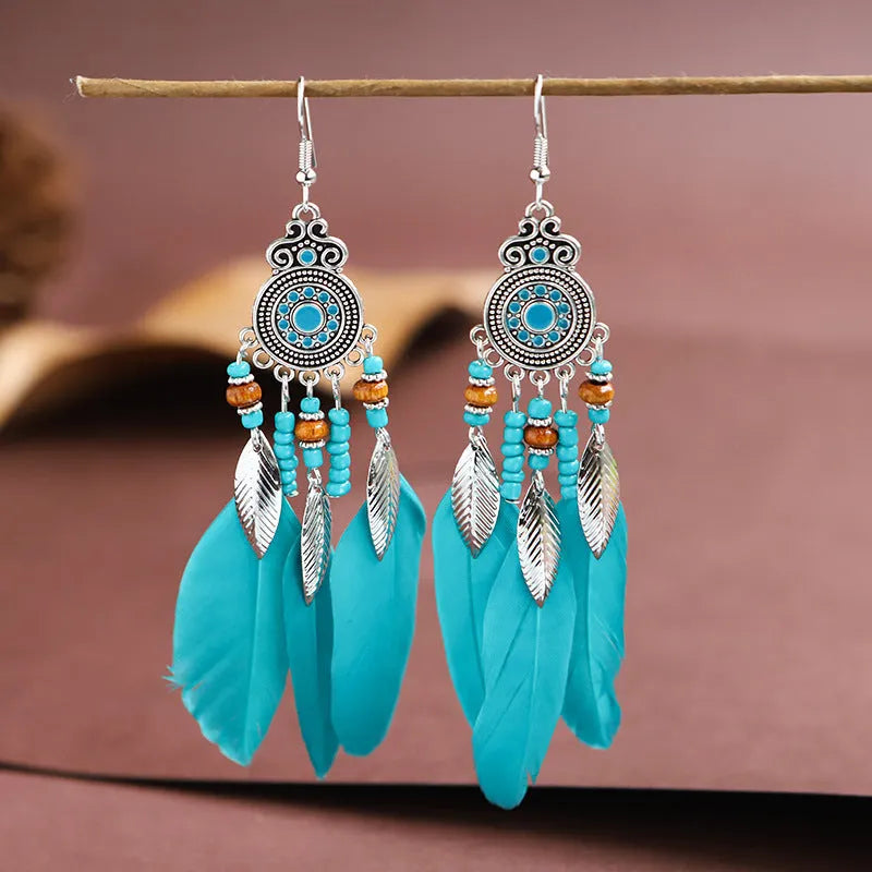 Round drop feather earrings with leaf patterning in alloy, available in multiple electroplated colours.