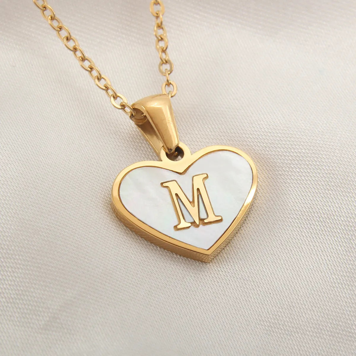 Gold-plated heart necklace with white shell design on adjustable stainless steel chain
