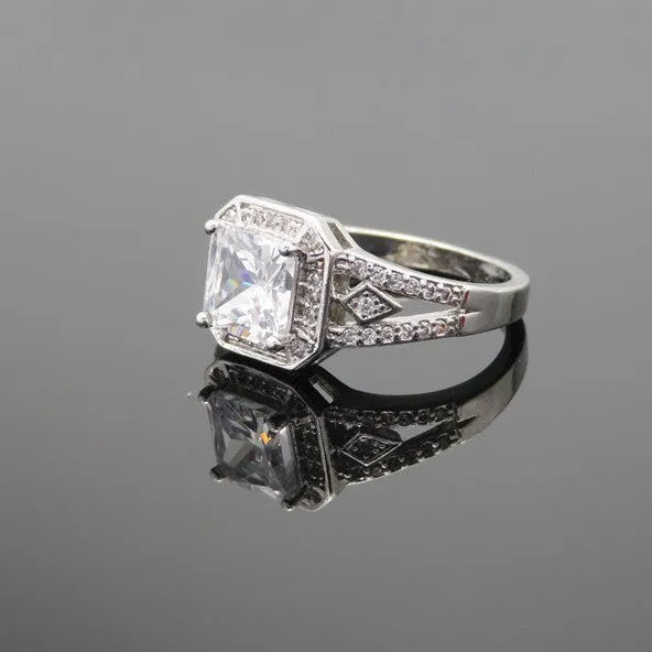 Geometric hollow zircon ring in platinum colour with four-sided design on woman's finger