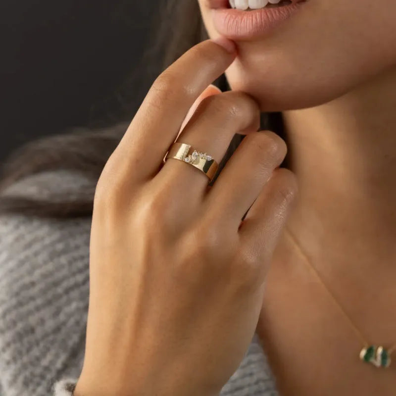 Gold electroplated copper women's ring with zircon stone centrepiece showing size options 6-10