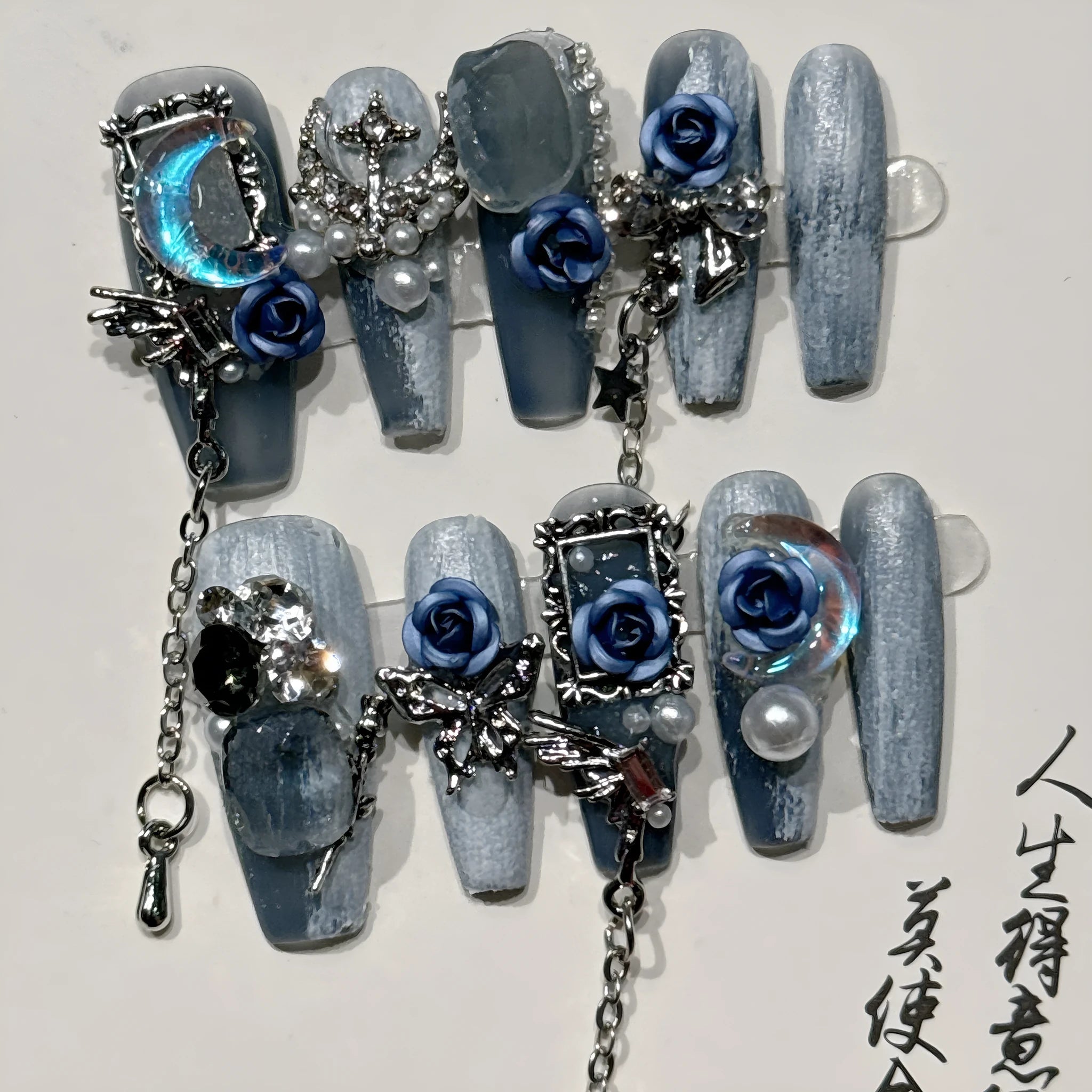 Heavy industry blue false nails with ornate rose and tulip pattern, shown in sizes XS S M L.