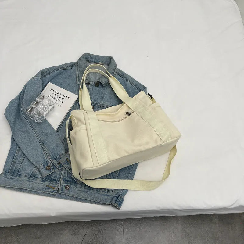Women's polyester canvas shoulder bag with sandwich pocket in black, white, brown, or green