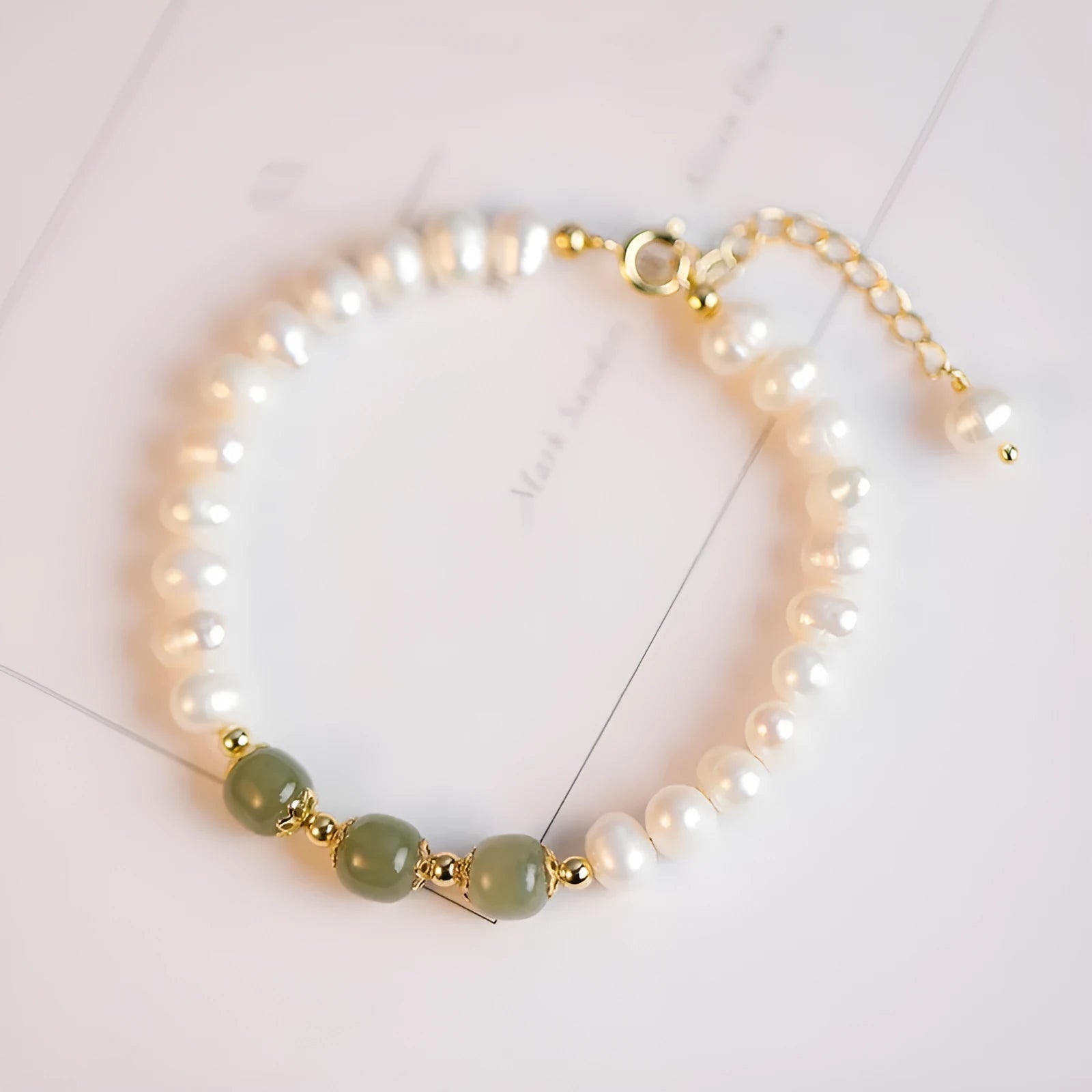 Natural freshwater pearl bracelet with diamond-shaped beads in Hetian jade colour on wrist