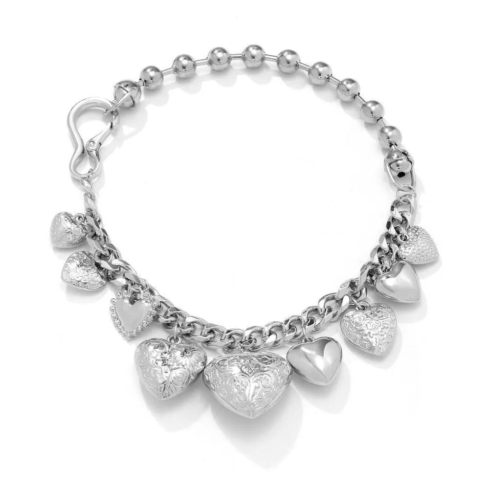 Gold carved heart pendant necklace with adjustable chain on white background