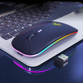 Black and white wireless mouse with silent buttons and luminous charging scroll wheel on a desk.