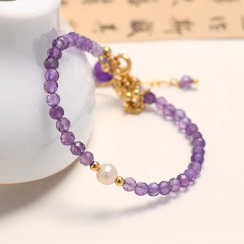 Chinese style women's bracelet with amethyst-coloured diamond-shaped crystals in electroplated metal setting