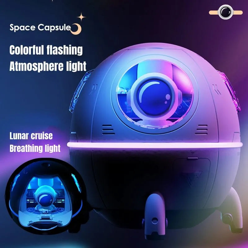 Purple astronaut-themed desktop USB humidifier with LED light next to USB cable on a desk.