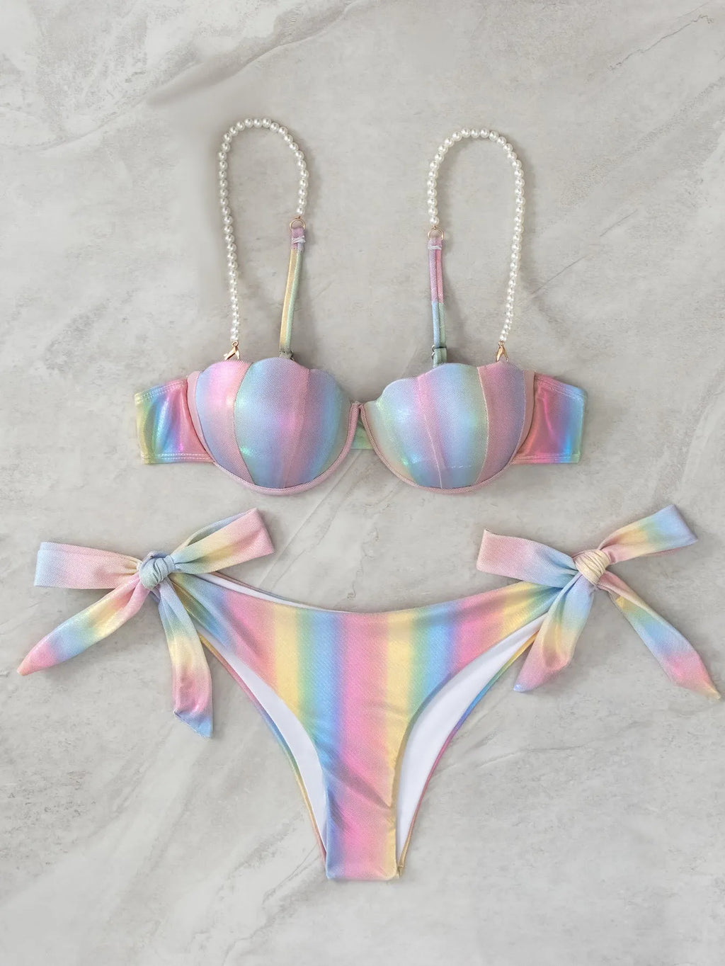 Women's rainbow shell bikini swimsuit with adjustable ties on top and bottom.