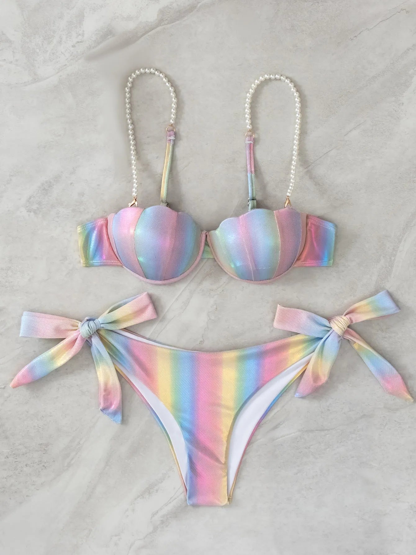 Women's rainbow shell bikini swimsuit with adjustable ties on top and bottom.