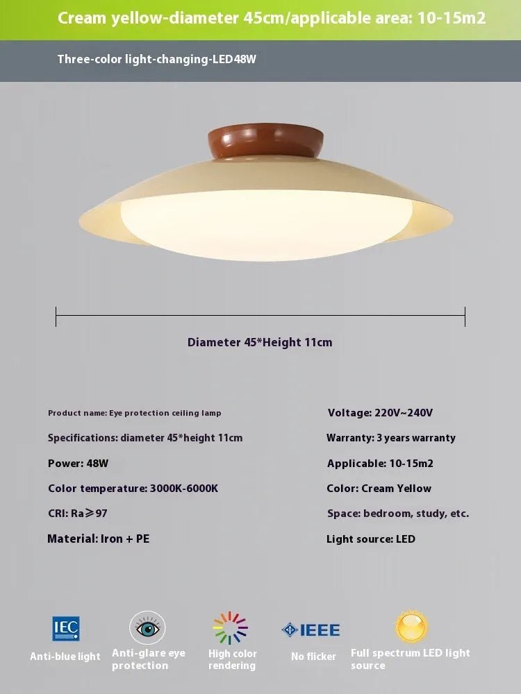 Modern minimalist cream style flying saucer ceiling lamp in mint green on a white ceiling.