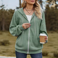 Green women's hooded zip-up sweater coat with long sleeves on a hanger.