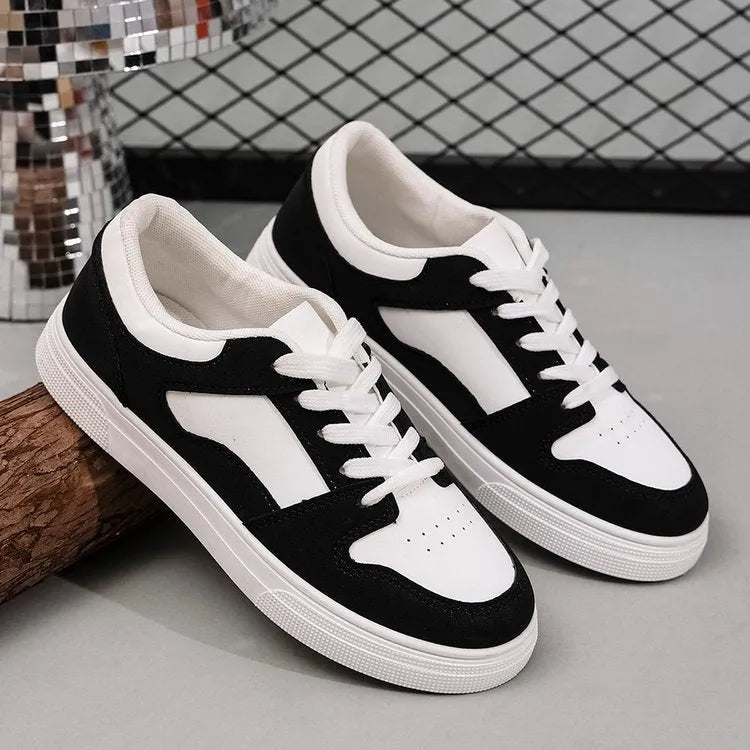 Black women's lace-up casual trainers with a round toe, low top, and rubber sole.