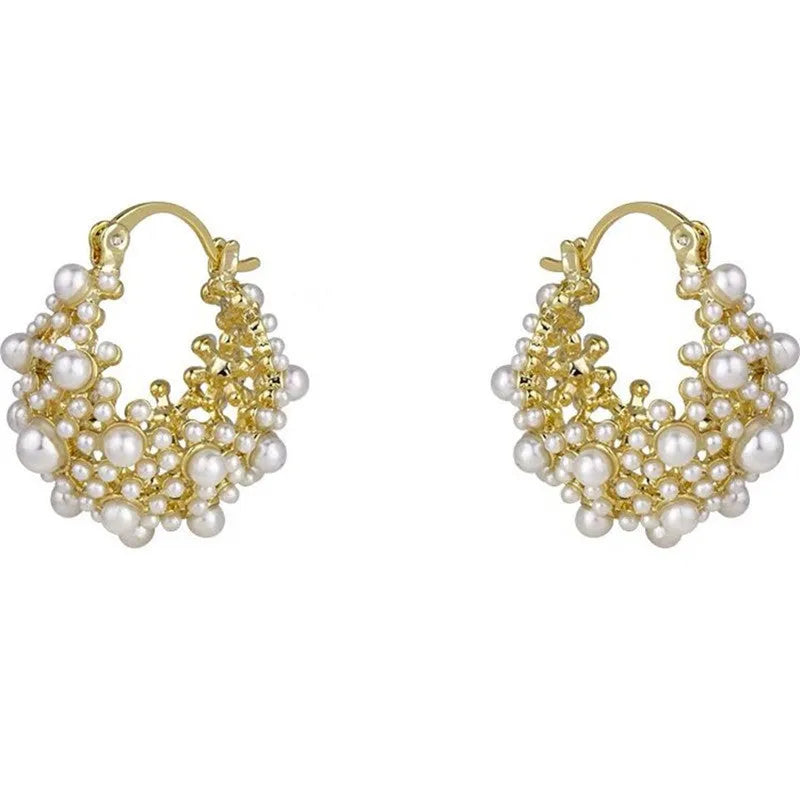 Gold-coloured copper flower basket earrings with small rice-shaped beads and pearl inlay detail.