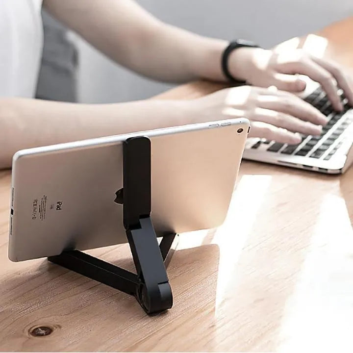 Black foldable tablet holder stand supporting a smartphone in landscape mode on a desk.