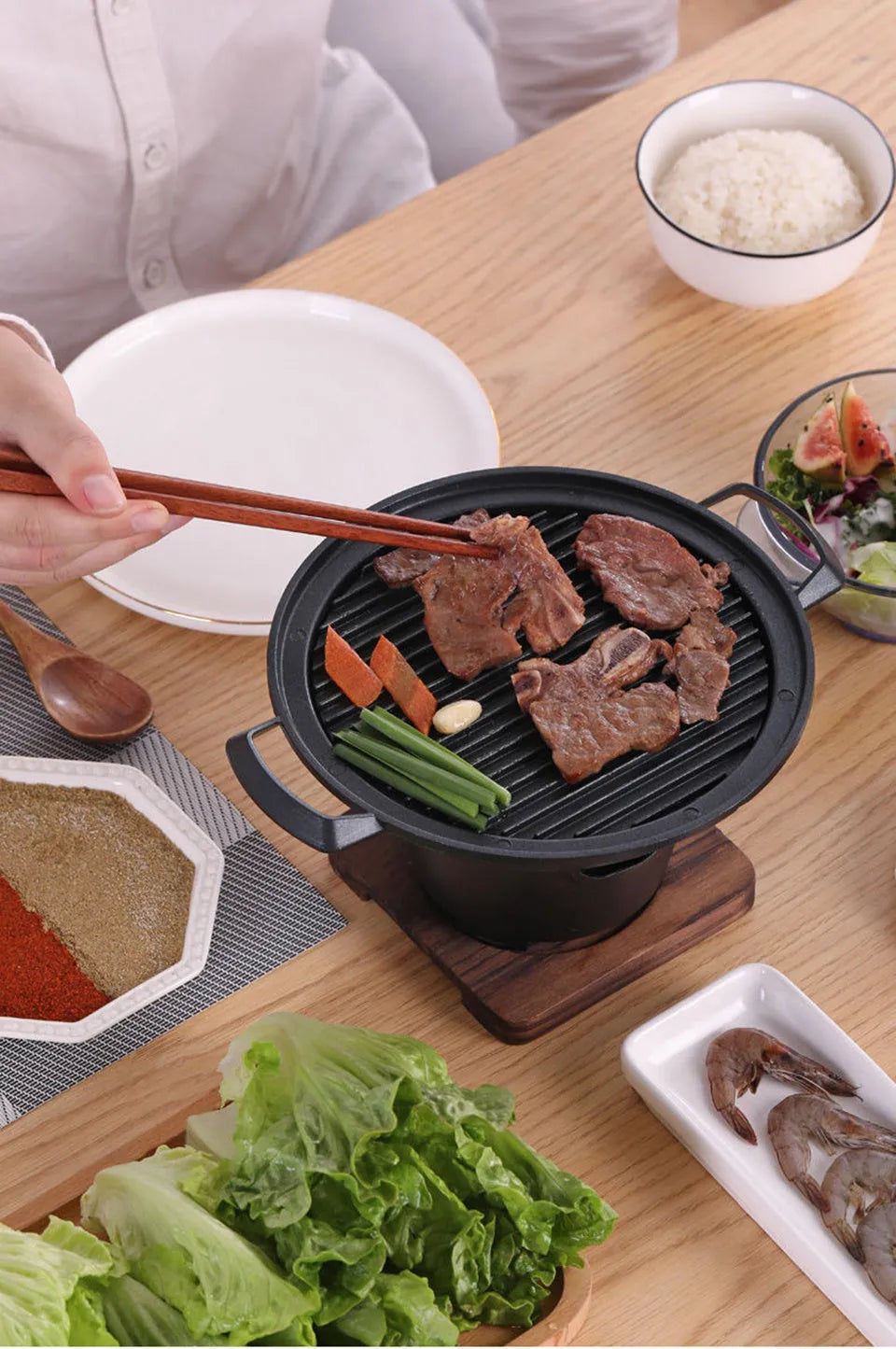 Mini BBQ grill alcohol stove with double-head flame and non-stick plate on tabletop