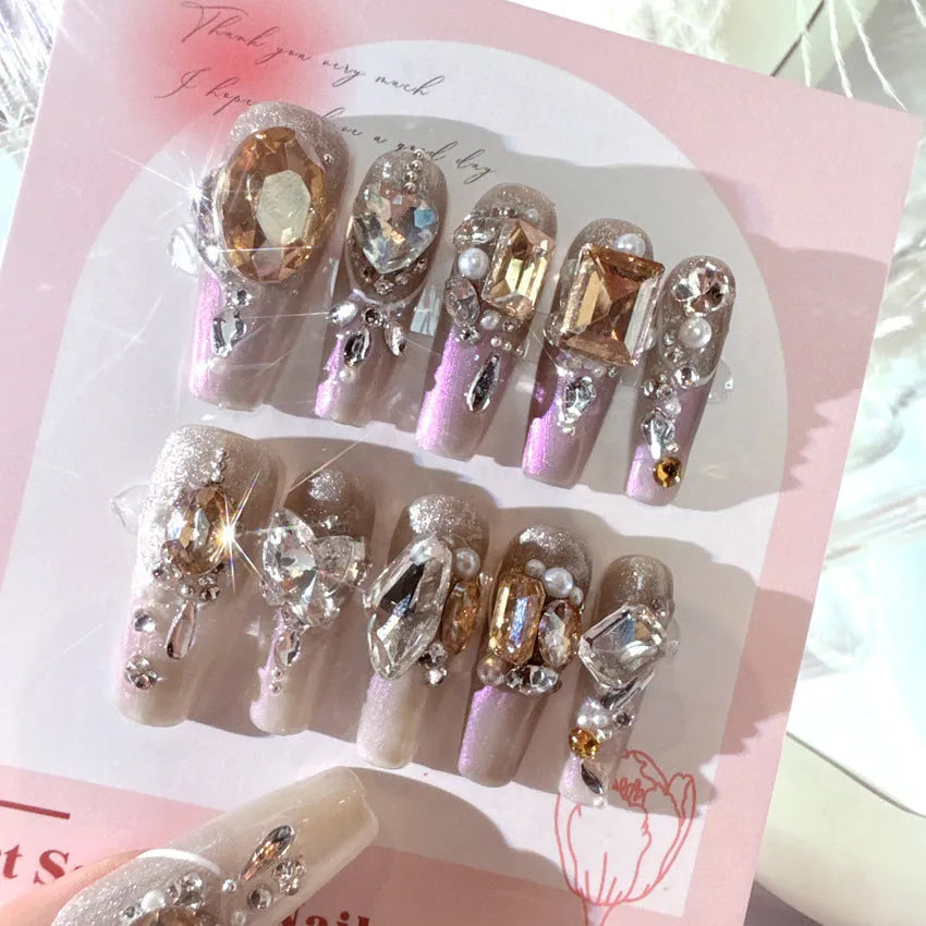 False nail patches with rhinestone detail on card paper packaging showing S number sizing