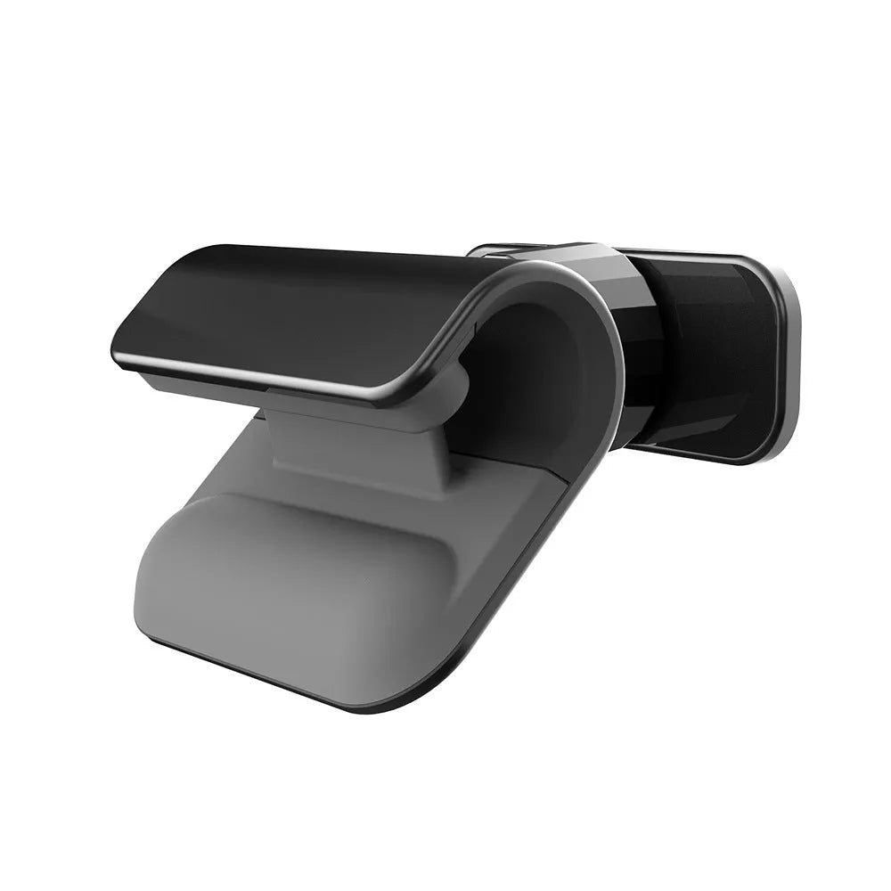 Black gravity car phone holder with 360-degree rotating head mounted on a car dashboard