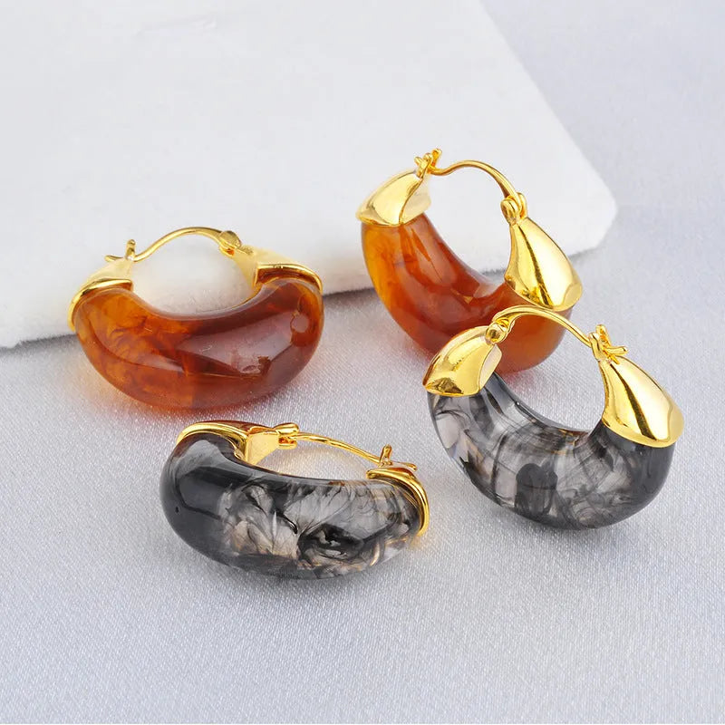 Copper geometry shape retro Maillard style earrings with electroplated finish in amber colour option on plain background