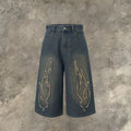 Men's black denim cropped shorts with flame embroidery patch design on leg