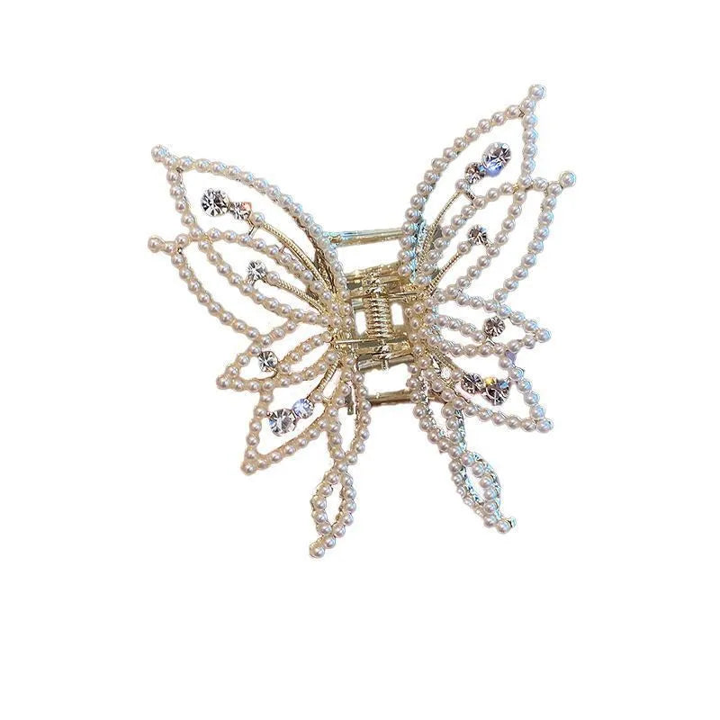 Butterfly-shaped hair clip with metal alloy construction and decorative rhinestone or pearl elements
