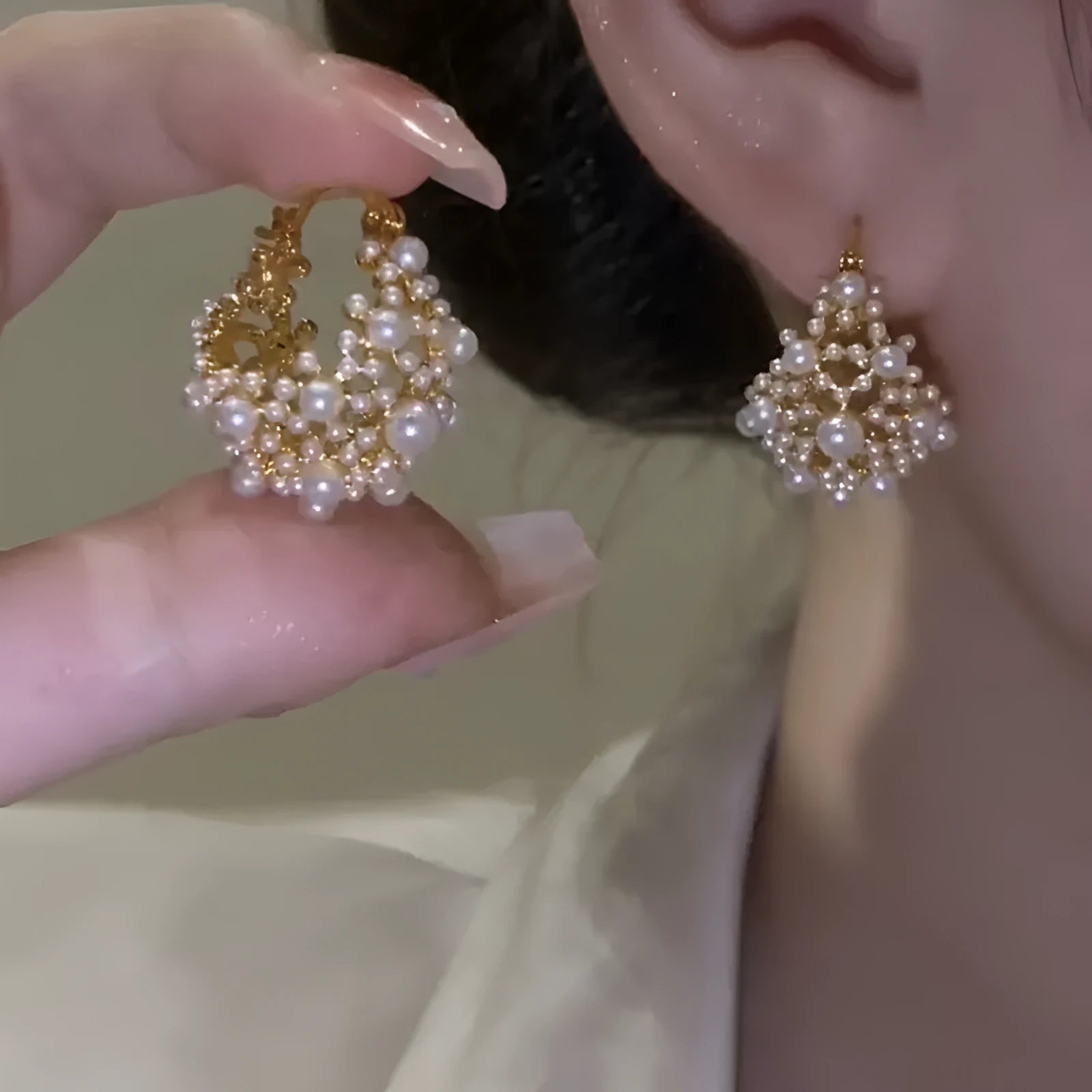 Gold-coloured copper flower basket earrings with small rice-shaped beads and pearl inlay detail.