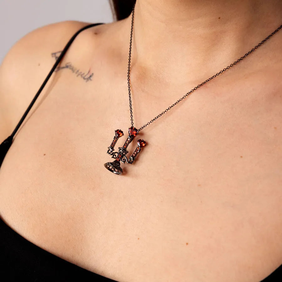 Close-up of a Gothic zinc alloy clavicle chain with a detailed hollow candlestick pendant on a cross chain.