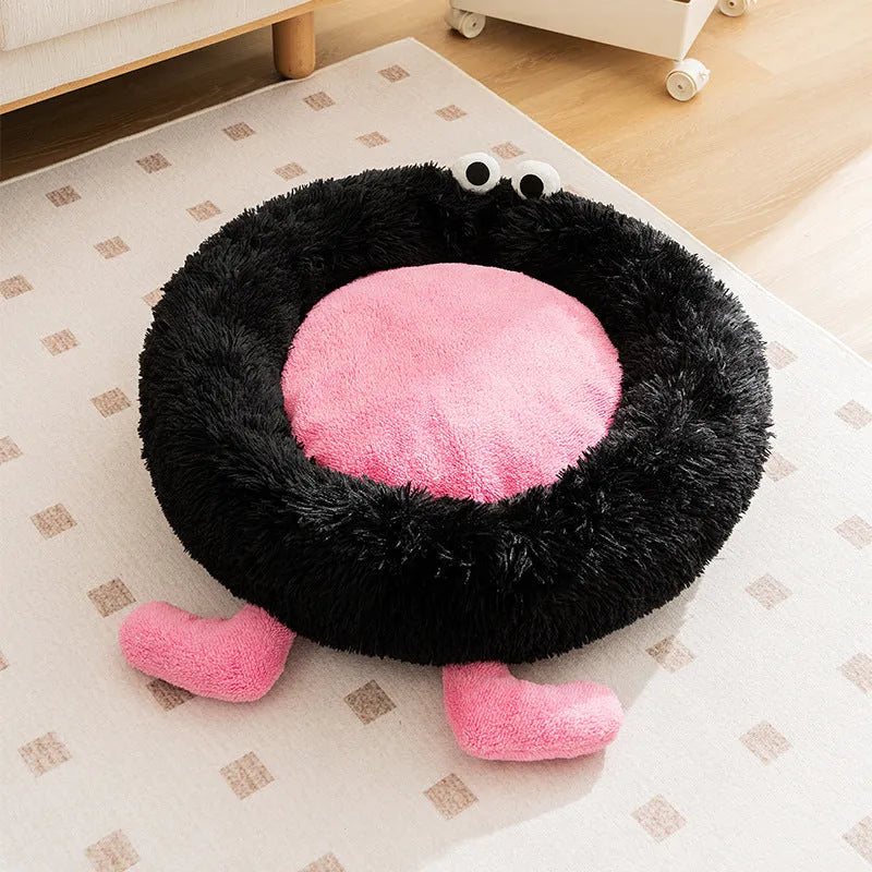 Blue plush kennel sleeping mat for small dog with raised edges, shown on a wooden floor.