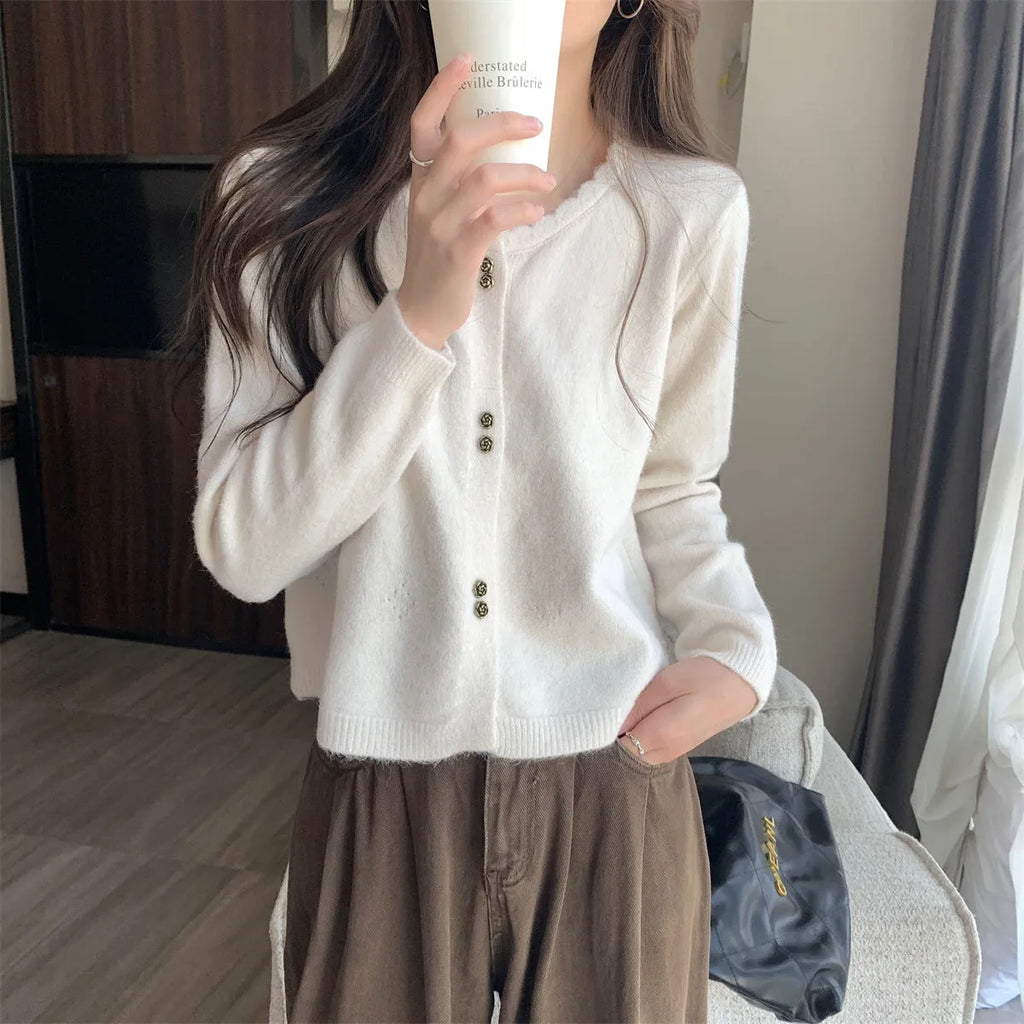 Women's long-sleeved acrylic cardigan sweater in milky white, shown with front open.