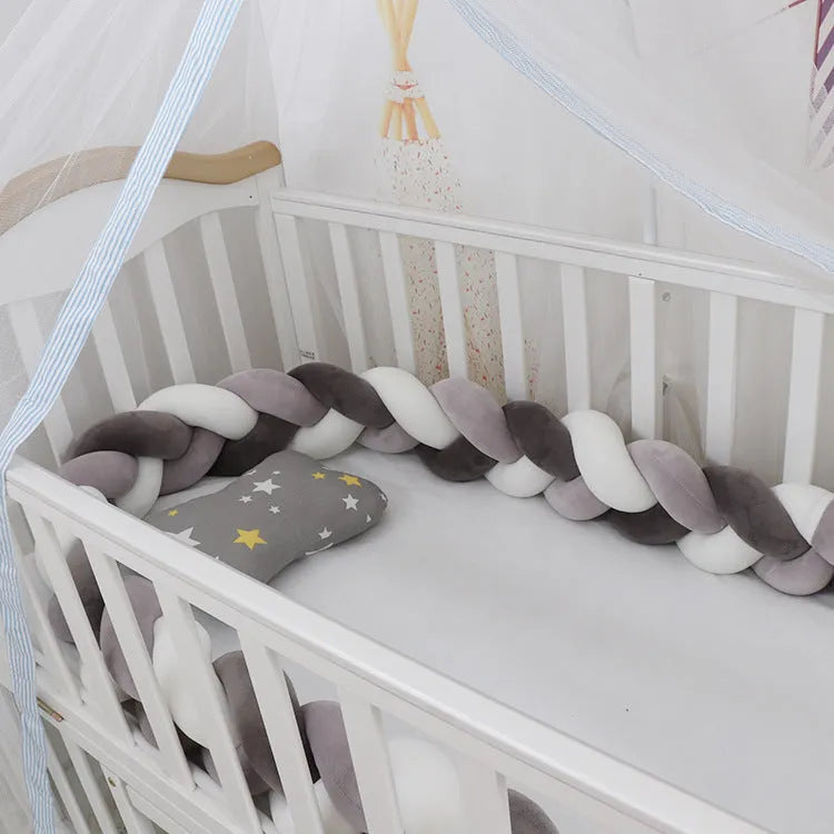 Multi-colour baby crib bumper made of spandex velvet, shown bent around a crib edge.