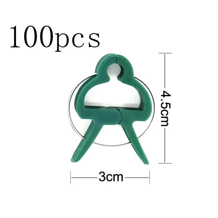 Green plastic and zinc plant fixing clips for supporting tomato vines and climbing plants in the garden.