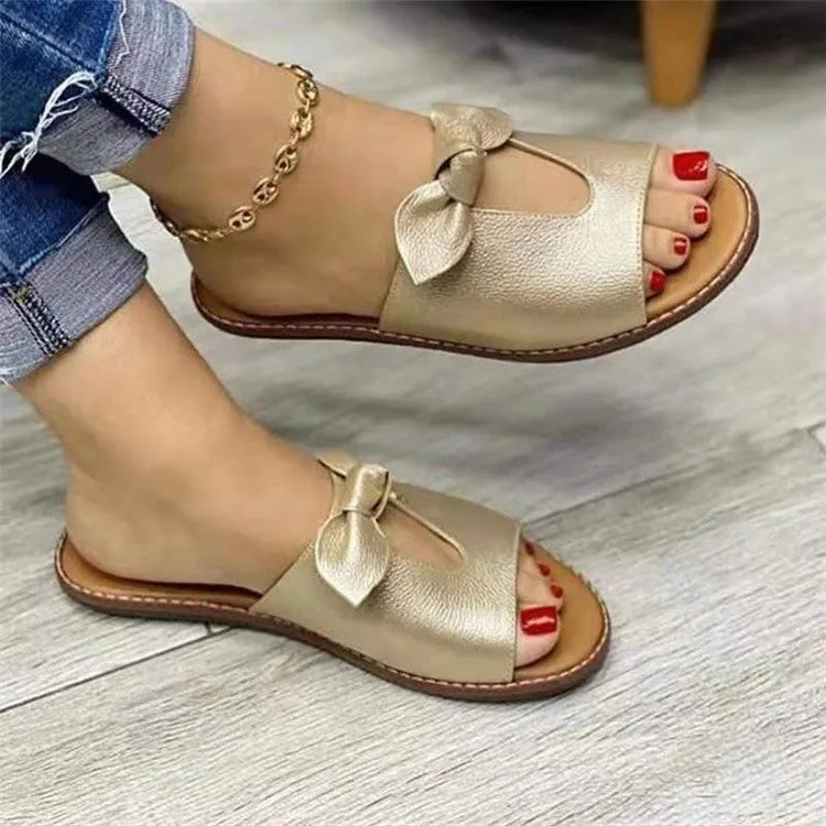 Ladies fish mouth style sandals with a decorative bow on the artificial PU upper, shown in black.