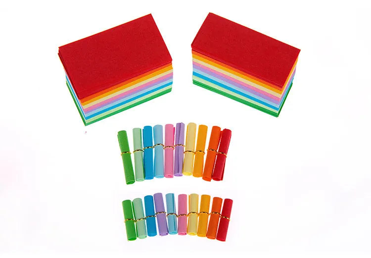 Multi-coloured mini paper scrolls in various sizes with metal eyelets for hanging.