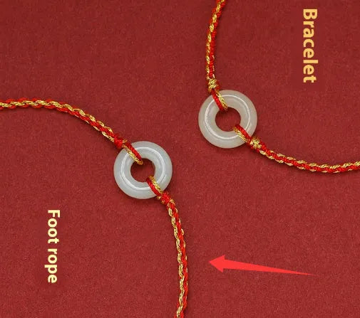 Red rope braided bracelet with natural wave-shaped Hetian jade pendant for Tiger Year birth year, on a neutral background