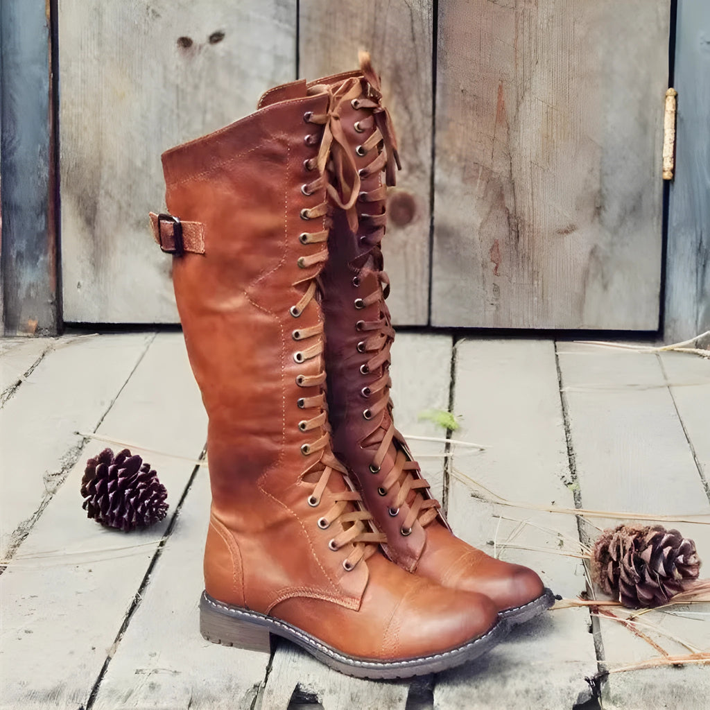 Women's black high leg boots with a round toe and low chunky heel on a plain background