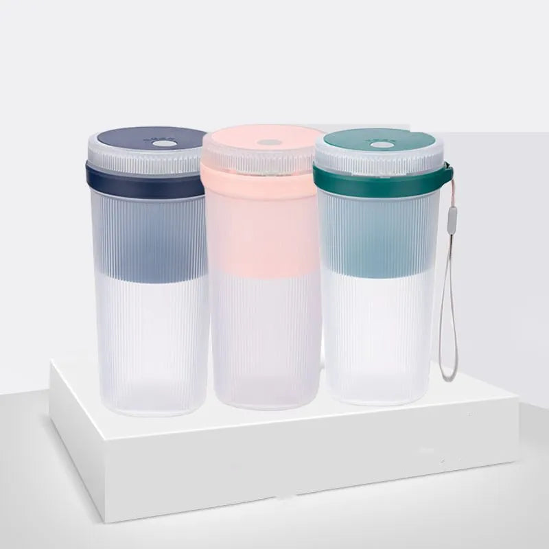 Portable electric blender cup in blue, green, or pink with USB charging cable.