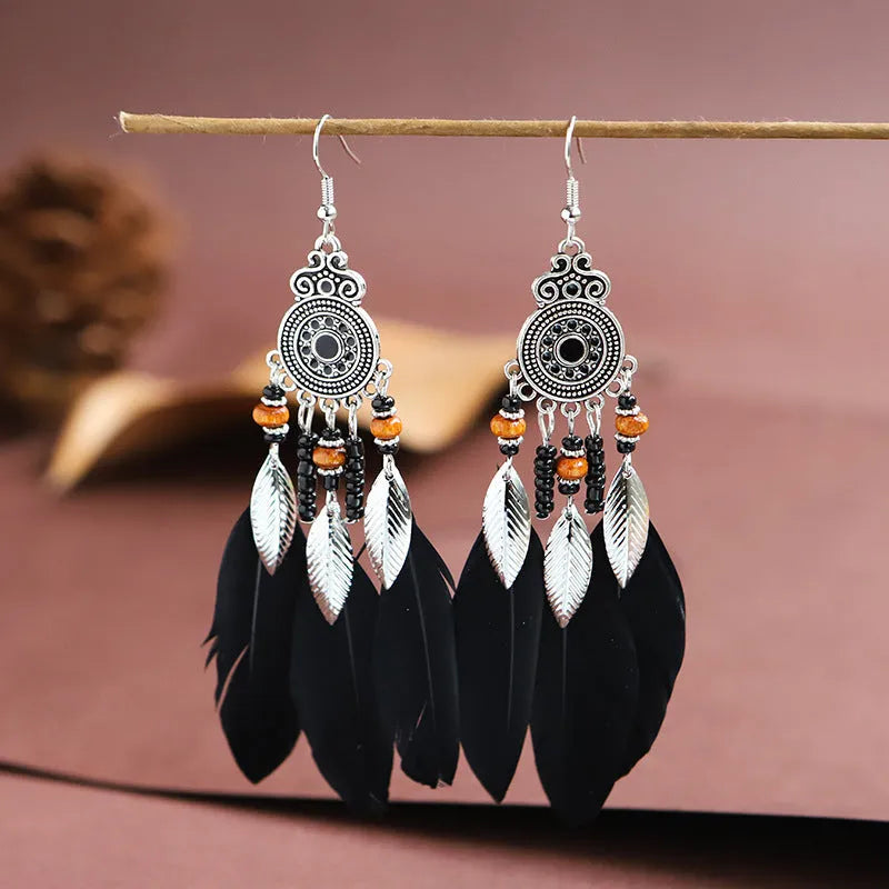 Round drop feather earrings with leaf patterning in alloy, available in multiple electroplated colours.