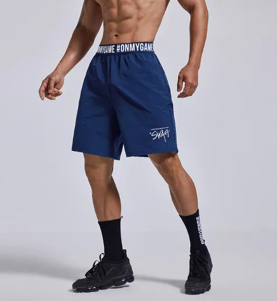 Men's loose black sports shorts with elastic waist and letters detail, laid flat.