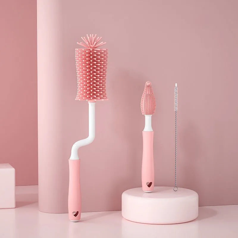 Blue, pink, and yellow silicone baby bottle brushes with an integrated straw cleaning tool.
