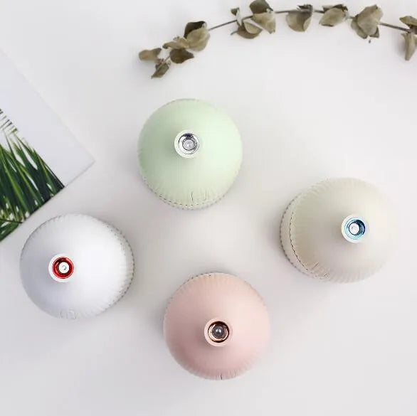 White ultrasonic essential oil diffuser and humidifier with LED light, 300ml capacity, USB cable.