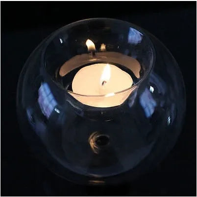 Hand-blown Europe style hollow glass candle holder in round design on table