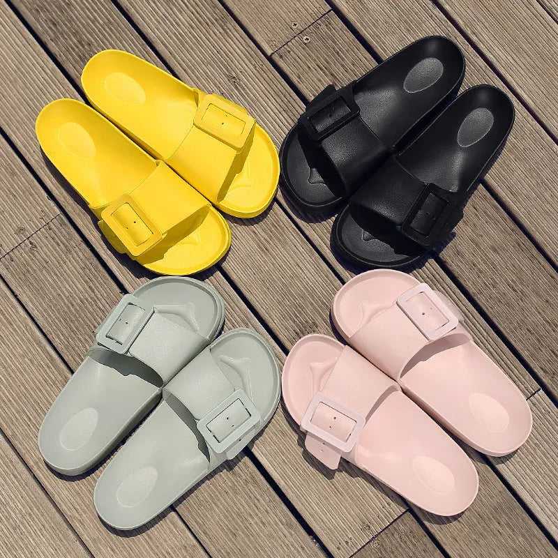 Women's grey blue buckle flip flops with a soft EVA sole on a plain background
