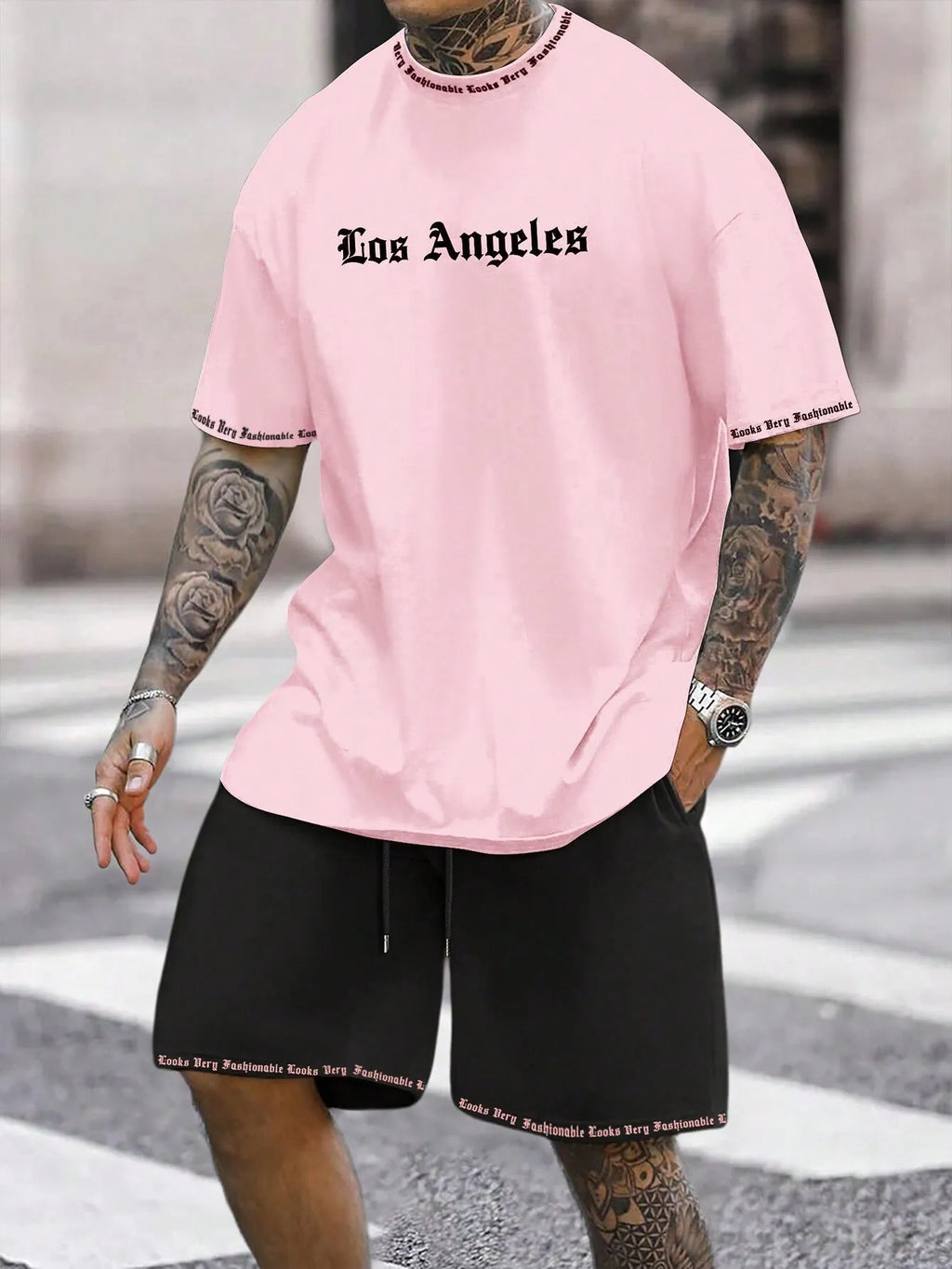 Men's grey sports short sleeve top and matching shorts set on hanger